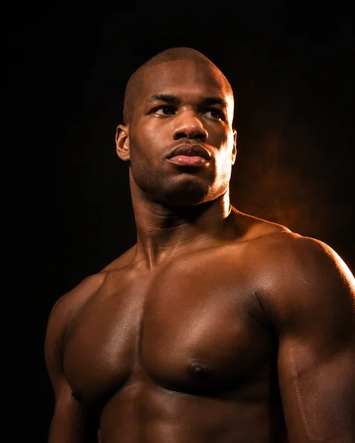 Daniel Dubois portrait against a dark background with warm light